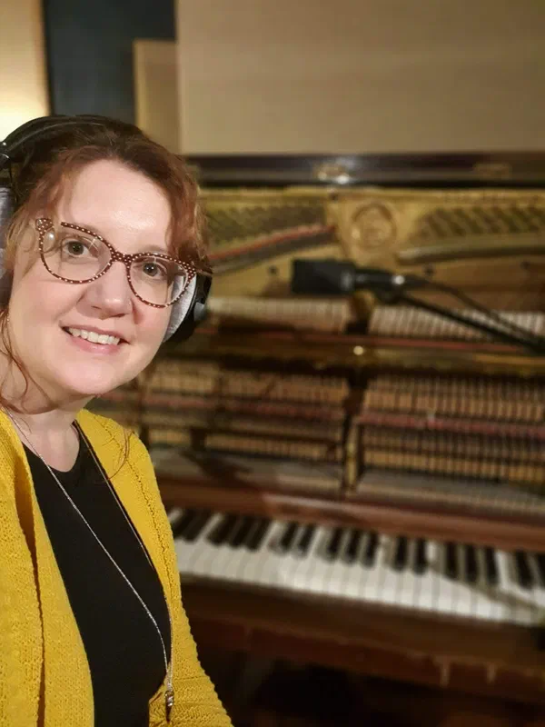 Sarah recording at an upright piano