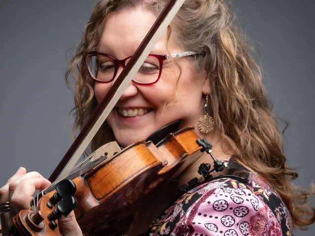 Sarah playing violin, close up, smiling