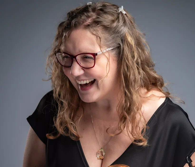Sarah laughing, holding her violin